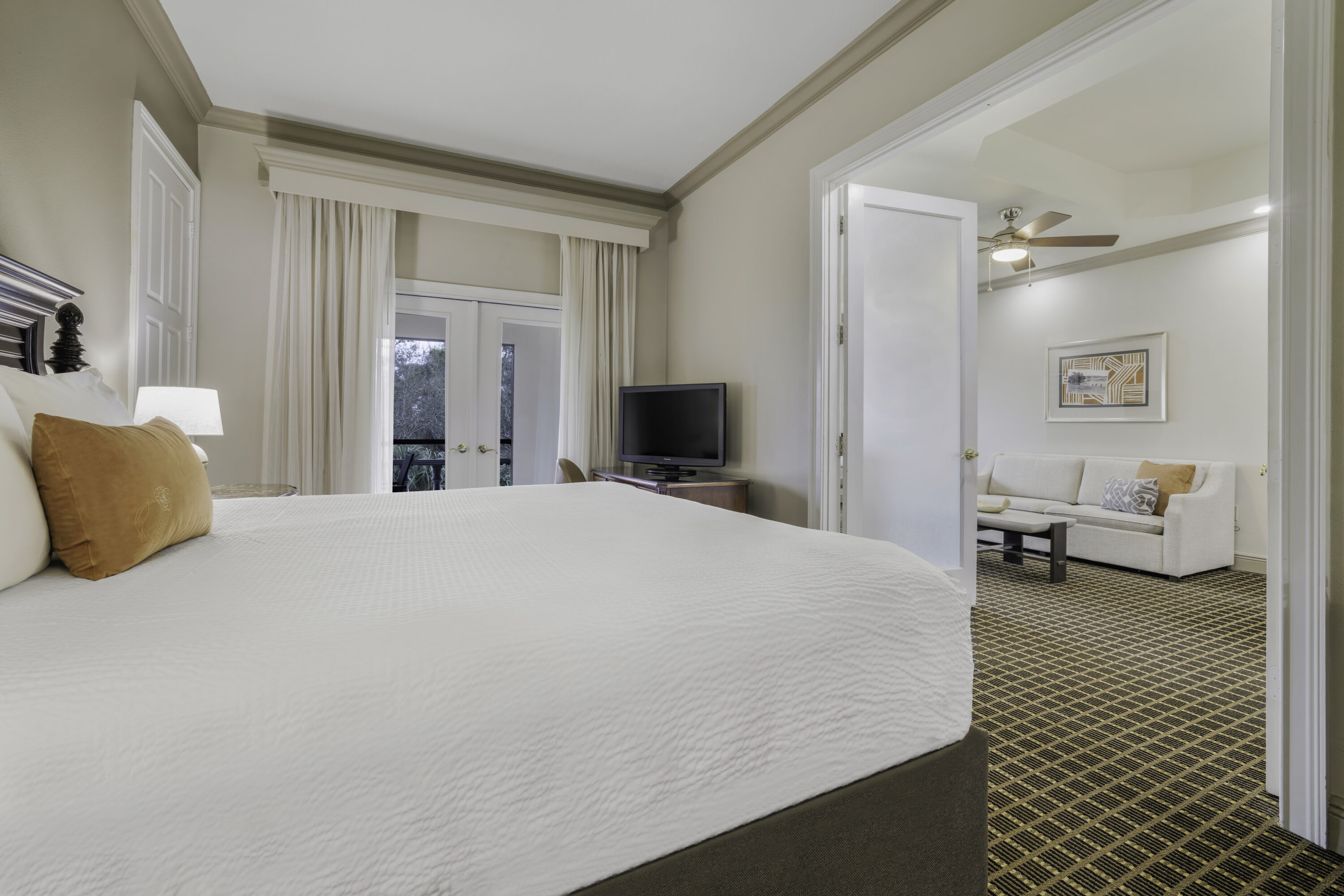 a bedroom with a bed and a television