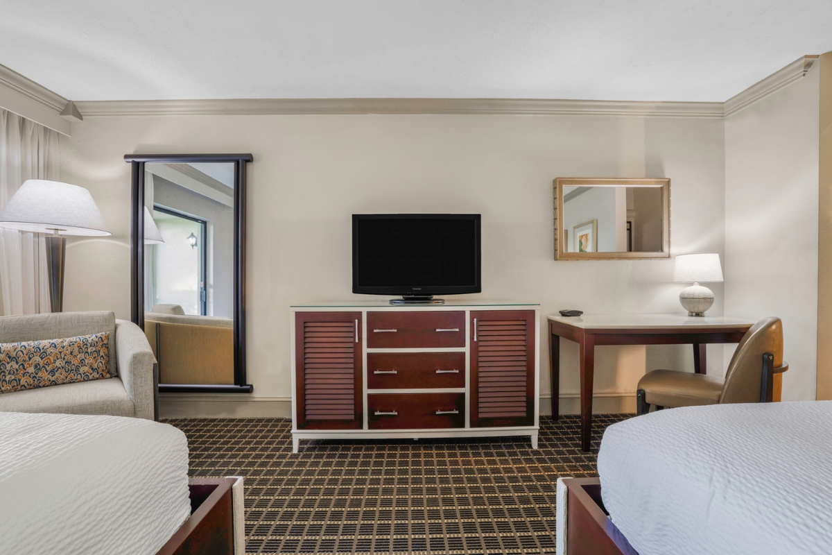 a room with two beds and a television