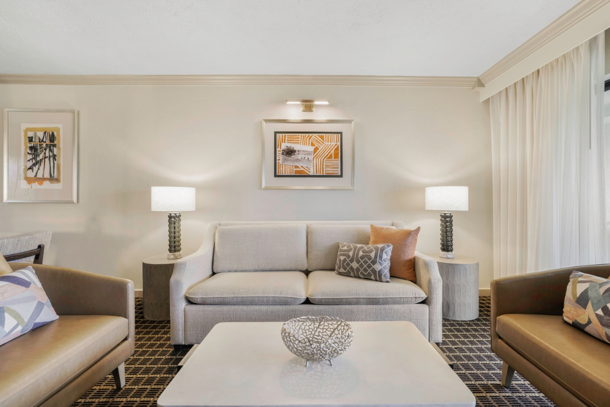 a room with a couch and two chairs