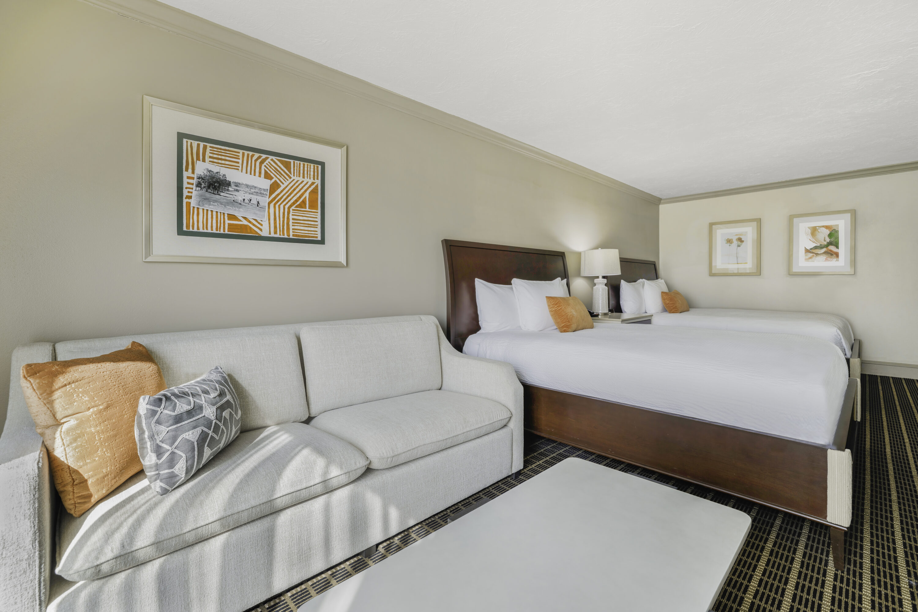a room with two beds and a couch