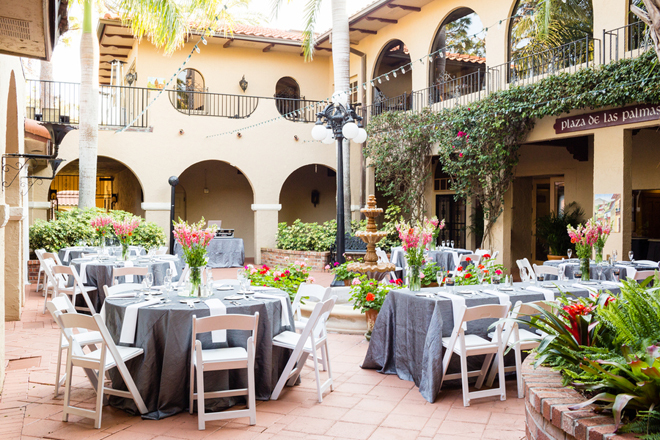 a courtyard with tables and chairs