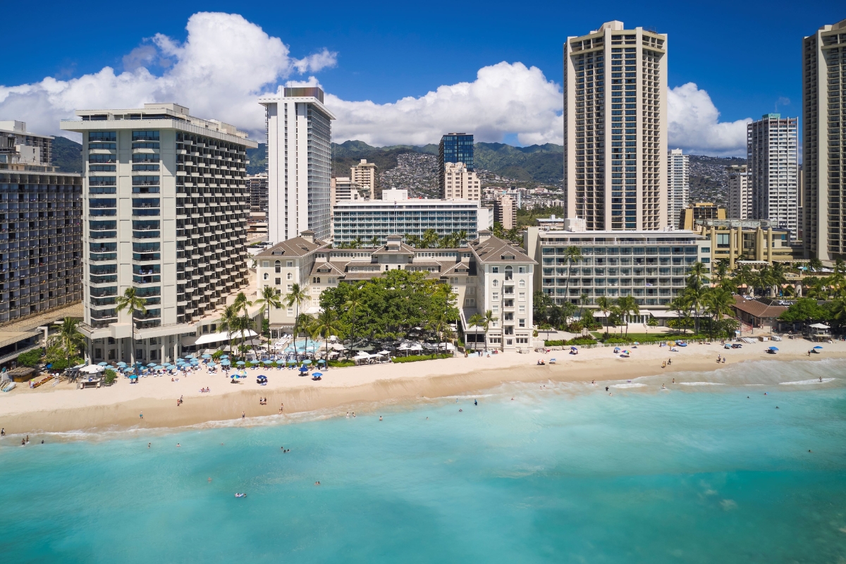 a beach with buildings and a body of water