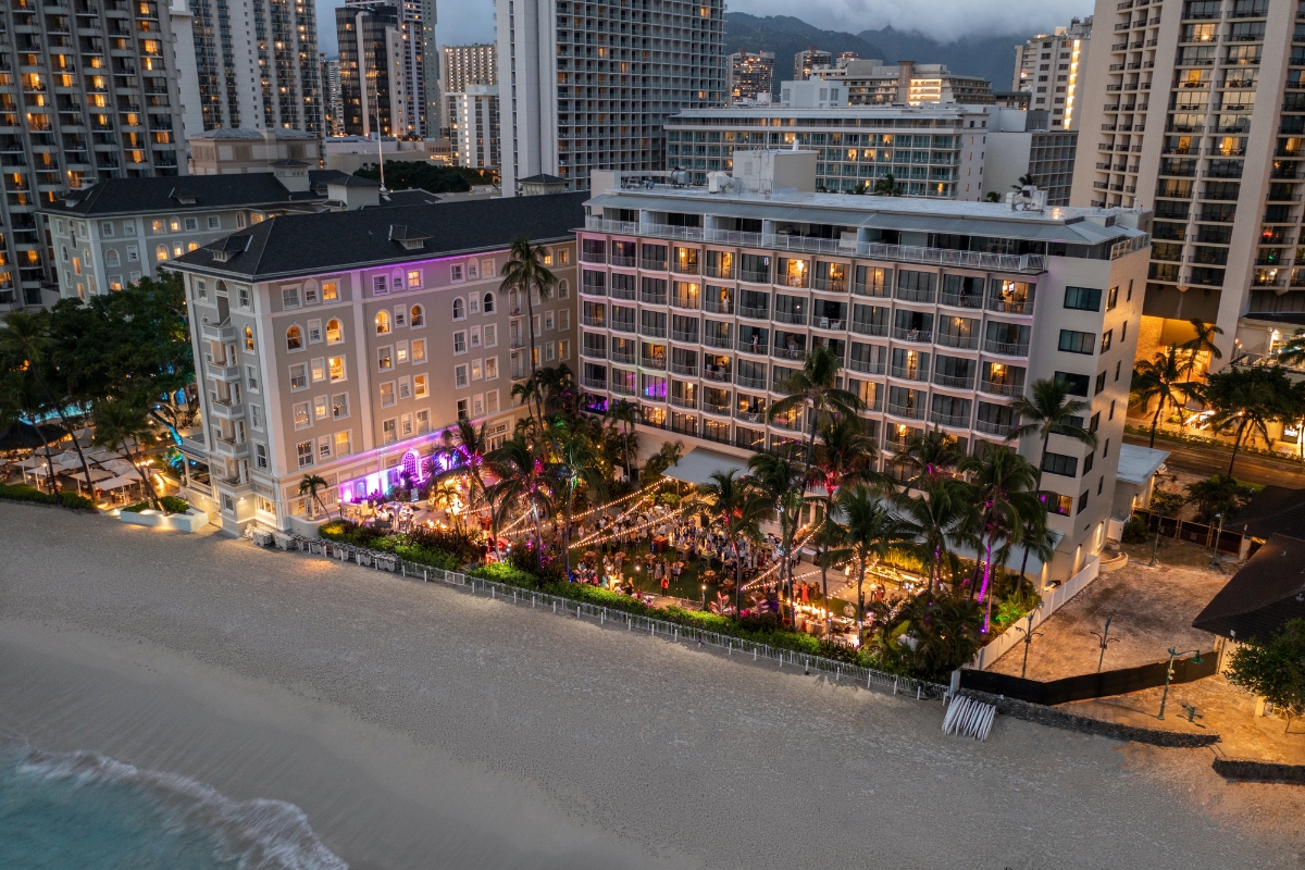 a beach with buildings and palm trees