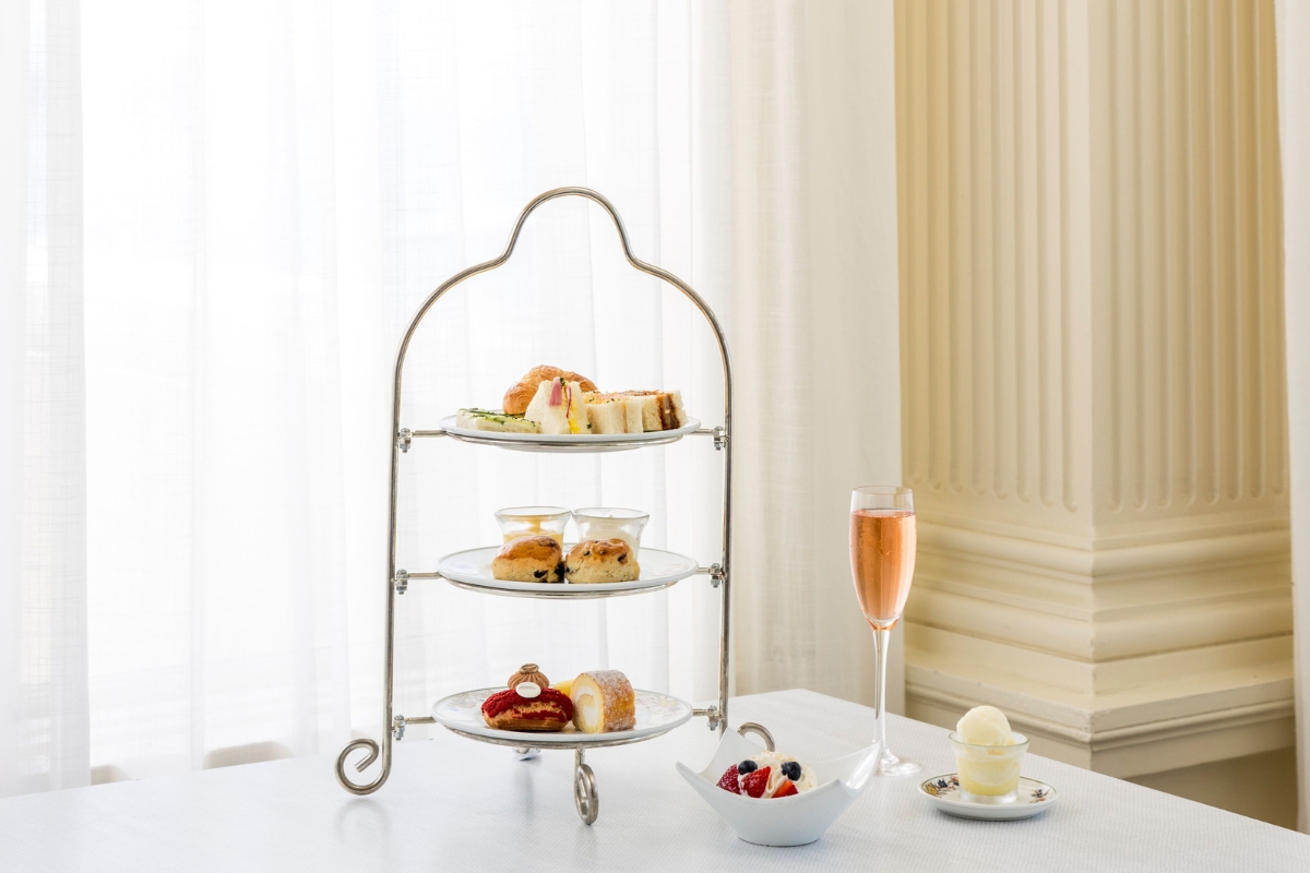 a three tiered tray with food on it