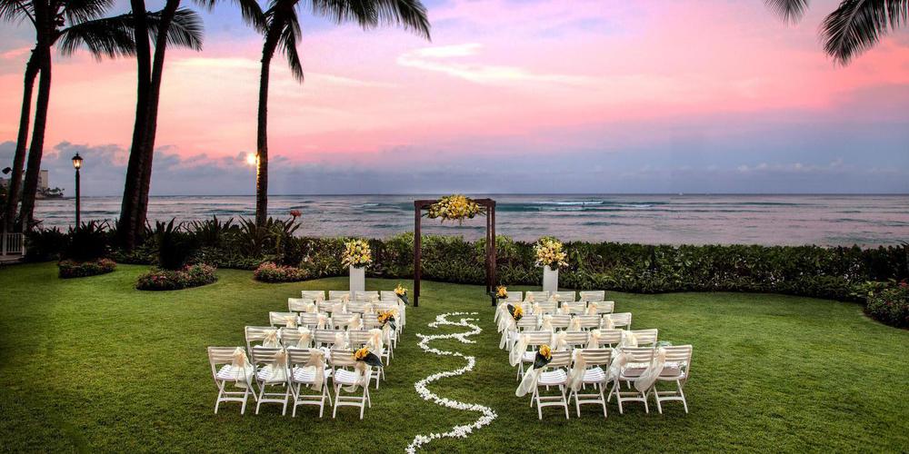 a wedding ceremony set up in a grassy area with chairs and flowers