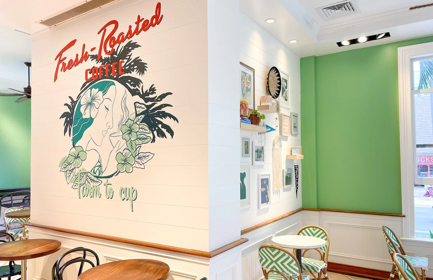 a room with a green wall and a table and chairs