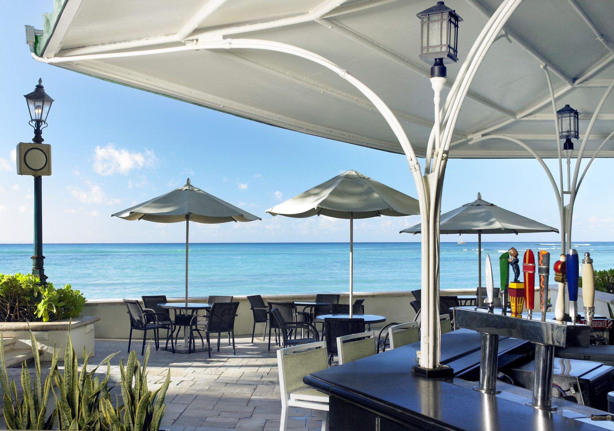 a patio with umbrellas and tables and chairs
