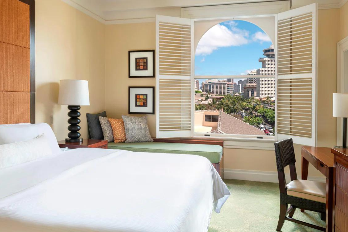 a bedroom with a window and a bed