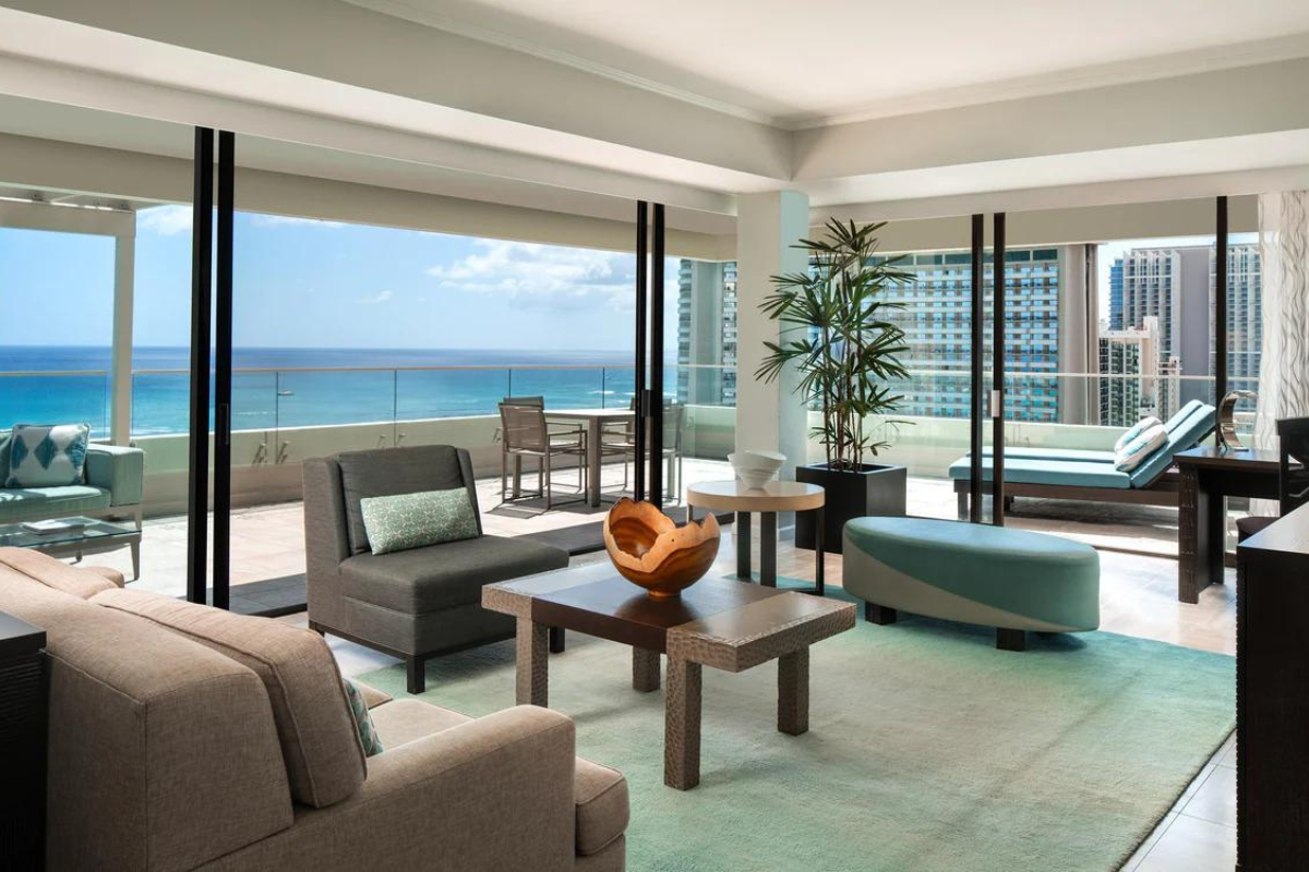 a living room with a view of the ocean