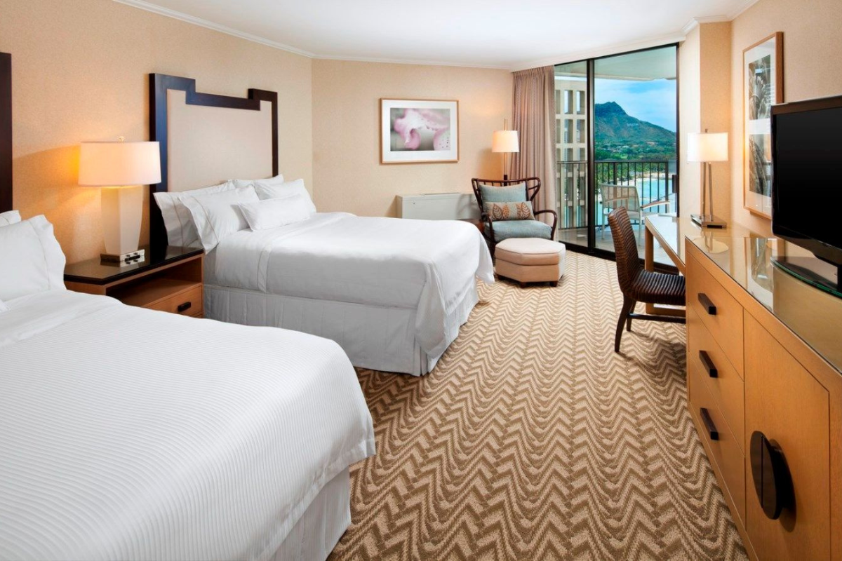 a room with two beds and a desk