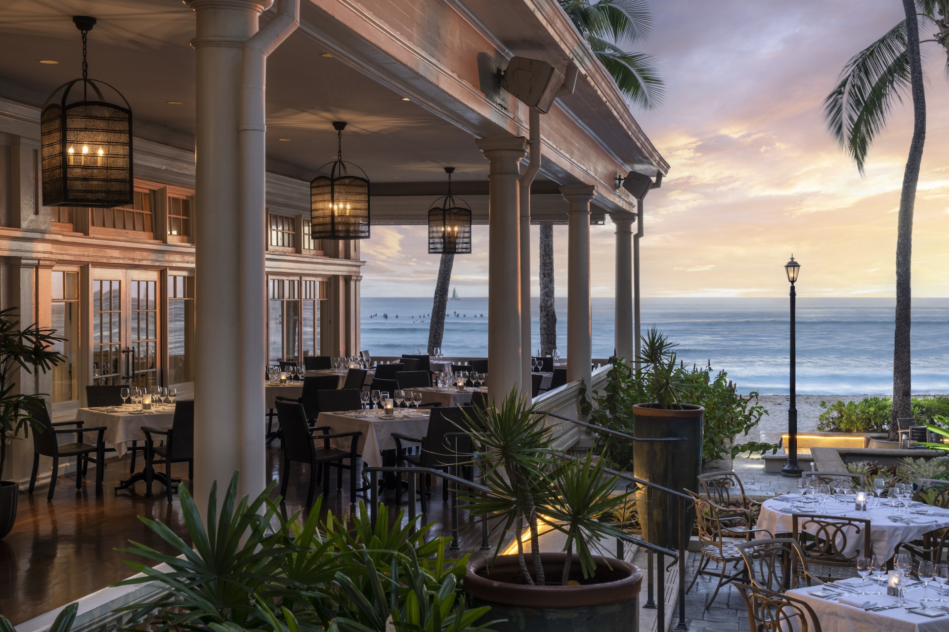 a restaurant with tables and chairs on a beach