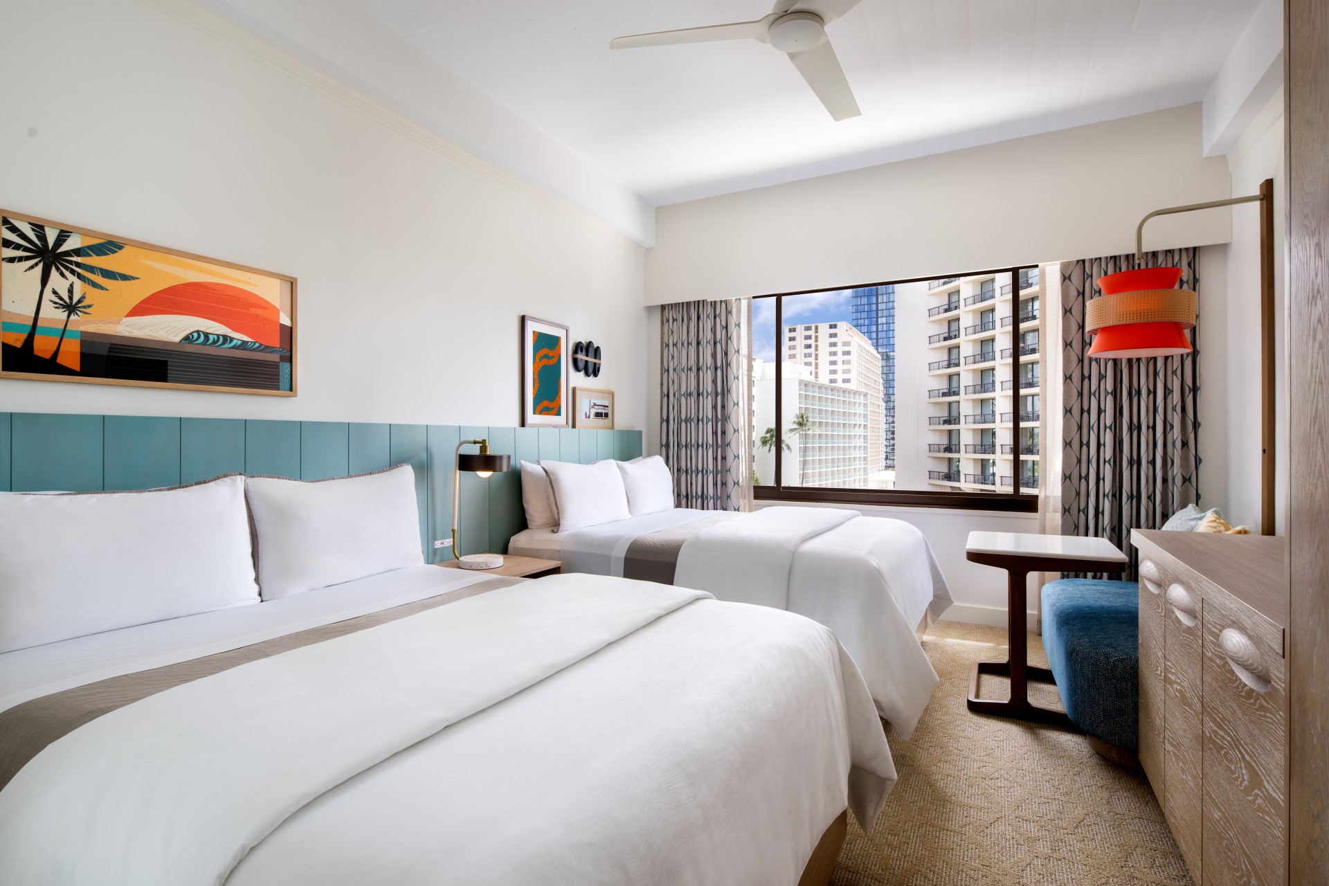 a room with two beds and a window