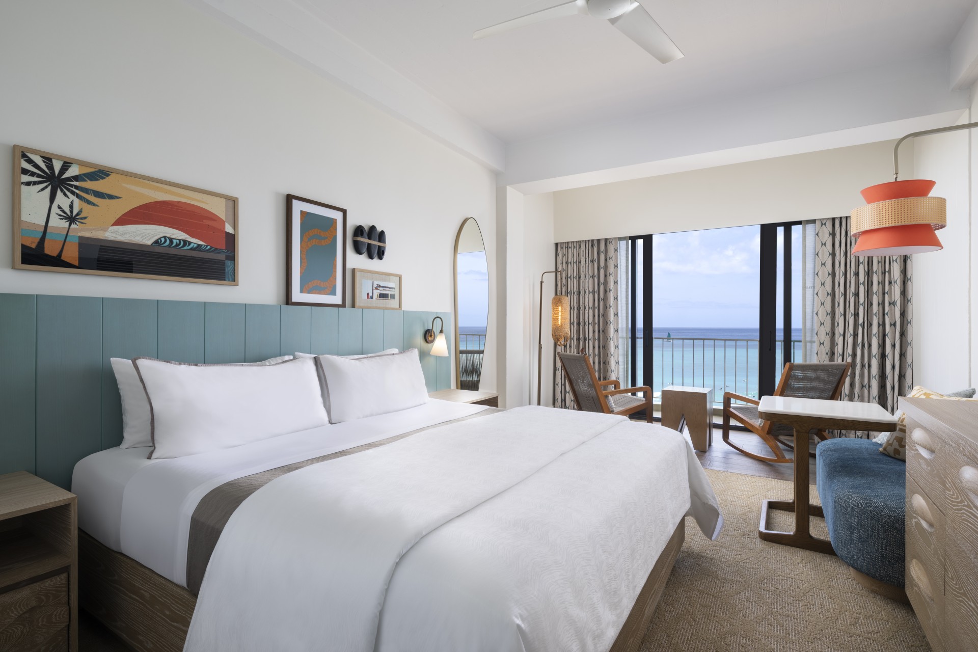 a bedroom with a large bed and a table and chairs