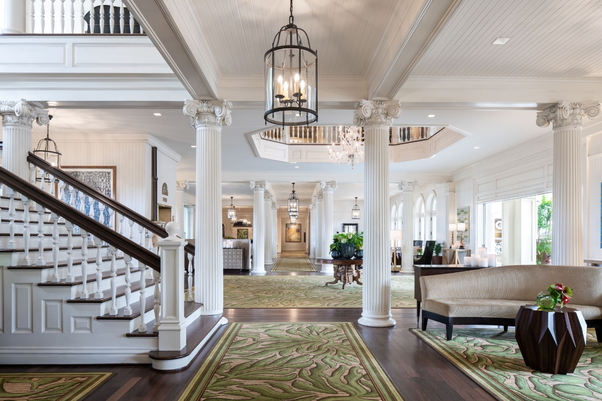 a large room with white columns and a chandelier