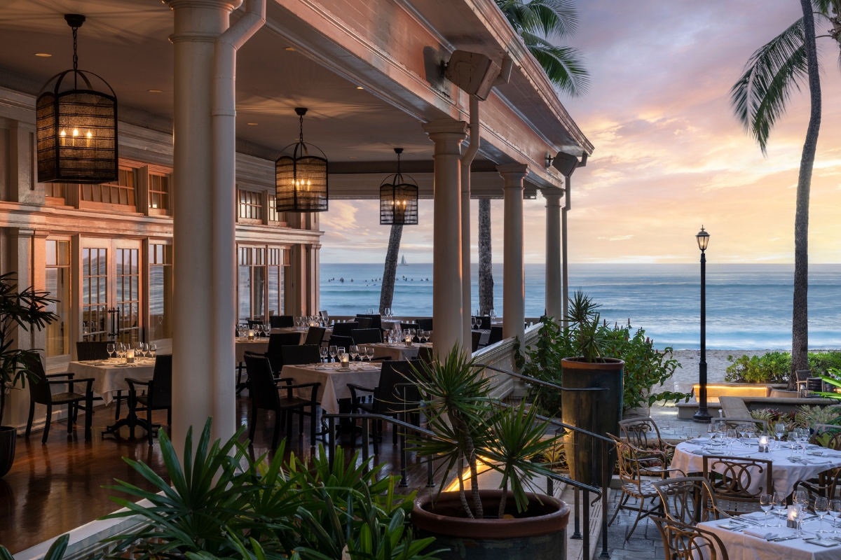 a restaurant with tables and chairs on a beach