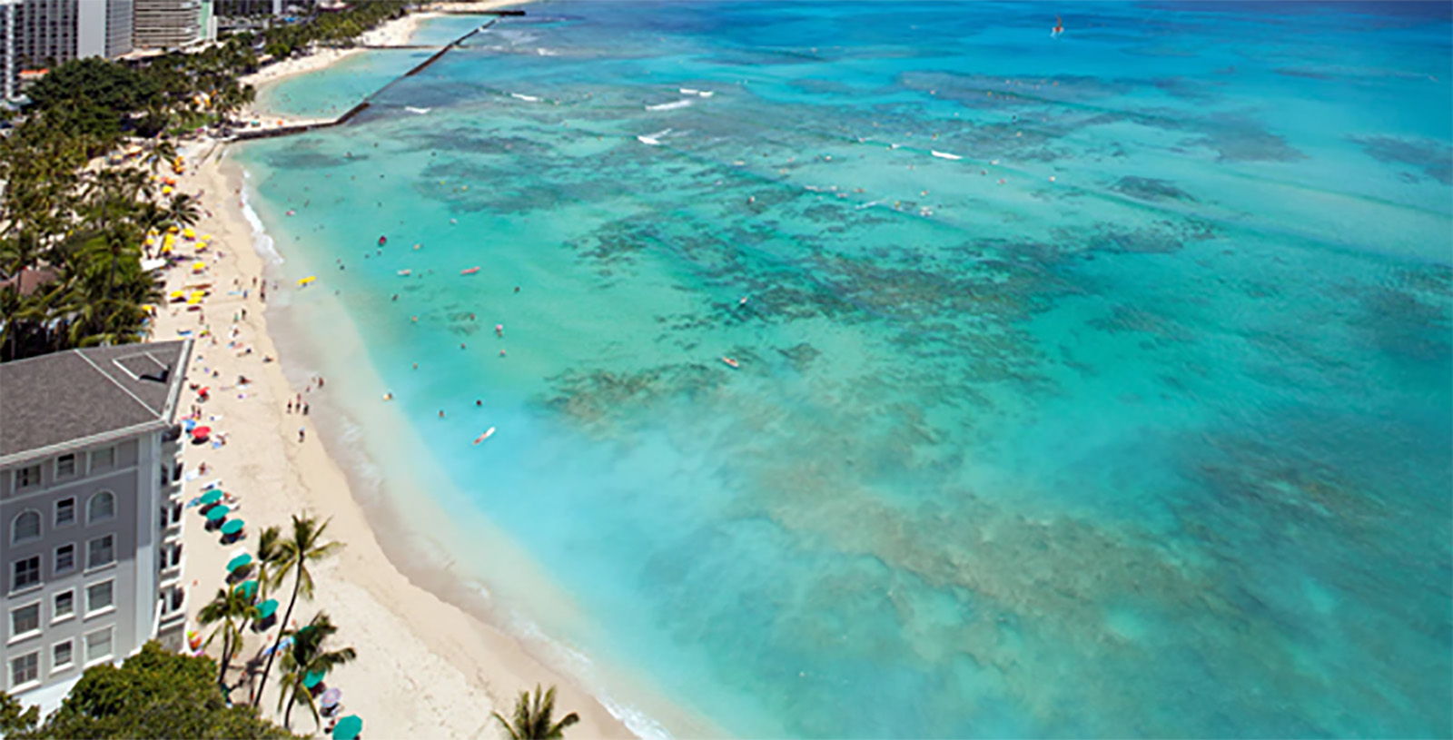 a beach with people swimming in the water