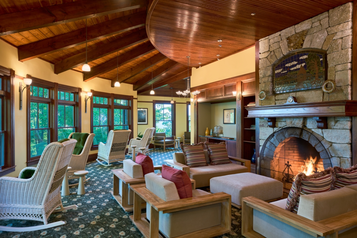 a room with a fireplace and chairs