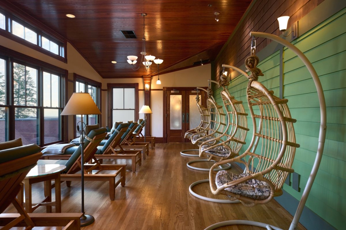 a room with chairs and a lamp