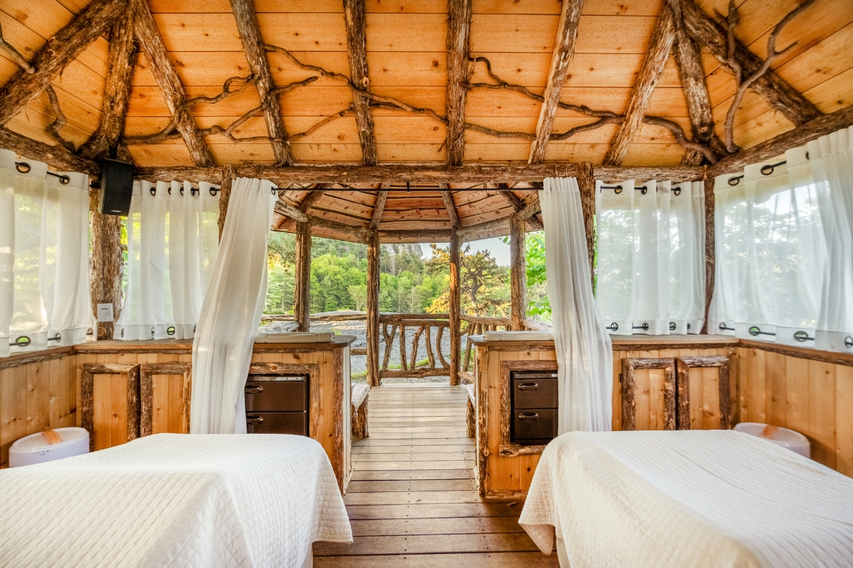 a room with two beds and a wooden ceiling