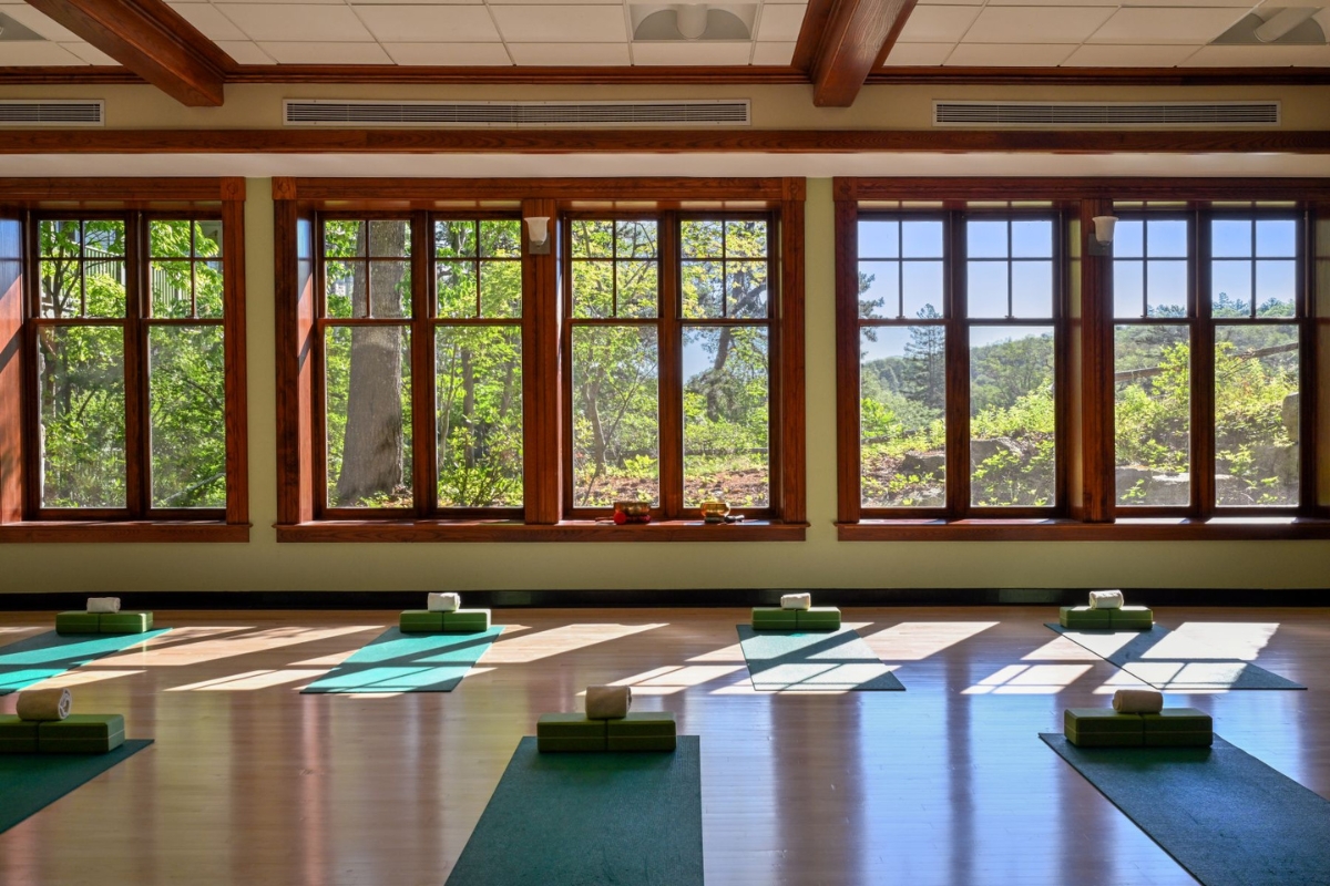 a room with mats and yoga mats in front of windows