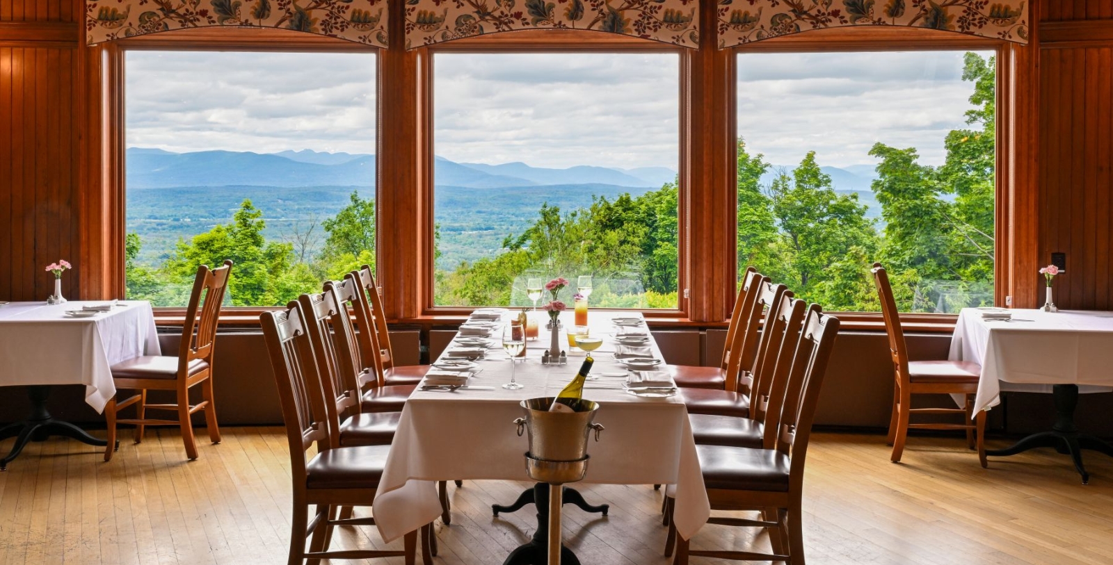 a table set for a dinner with a view of the mountains