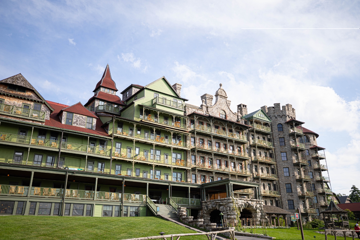 a large building with a stone wall and a stone walkway