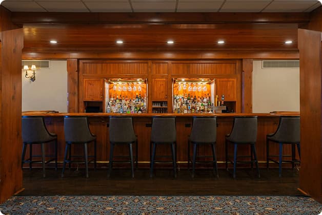 a bar with chairs and a counter