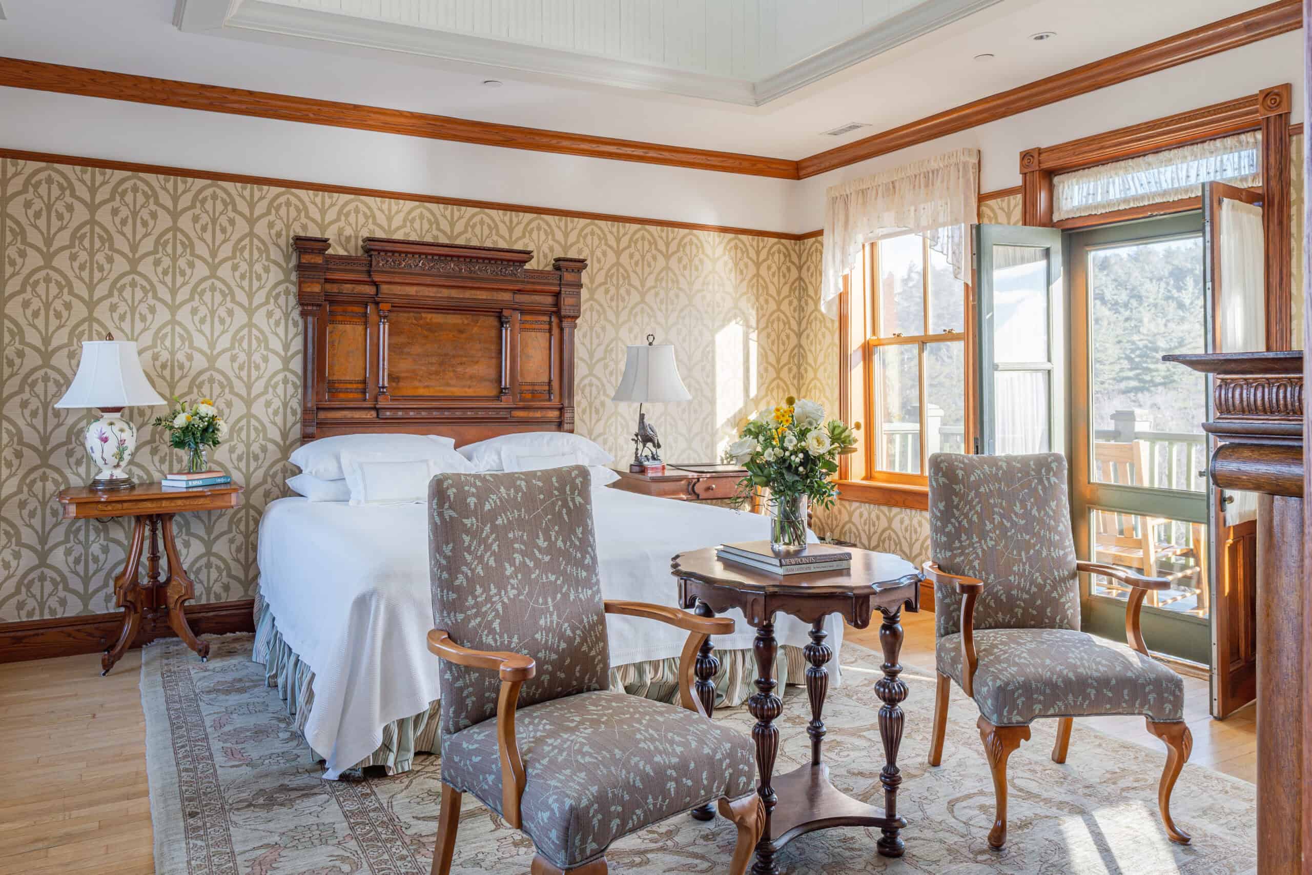 a room with a bed and chairs