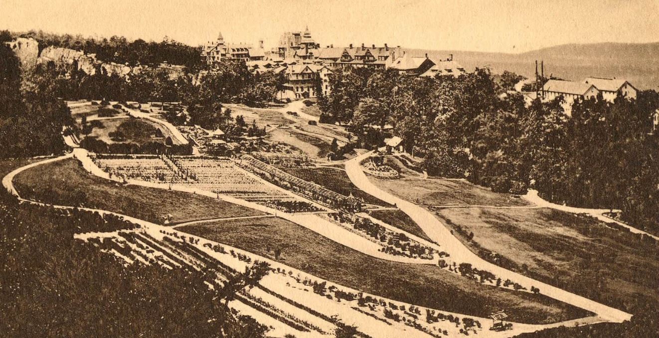 a landscape with a road and a large building