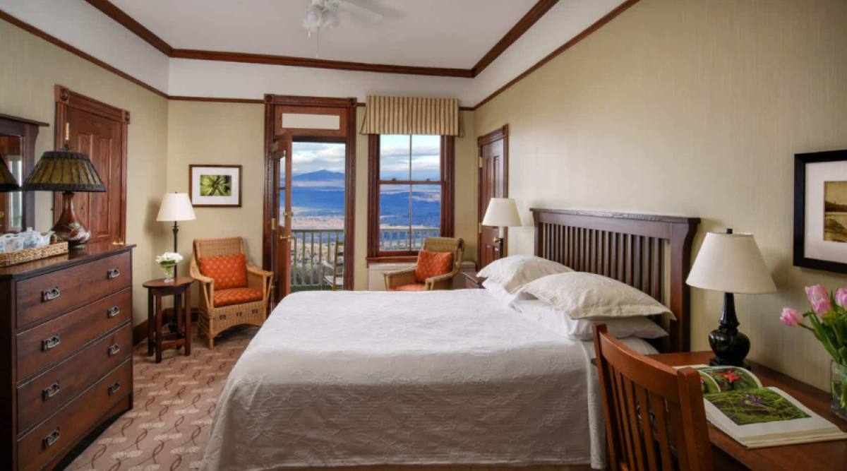 a bedroom with a large bed and a window