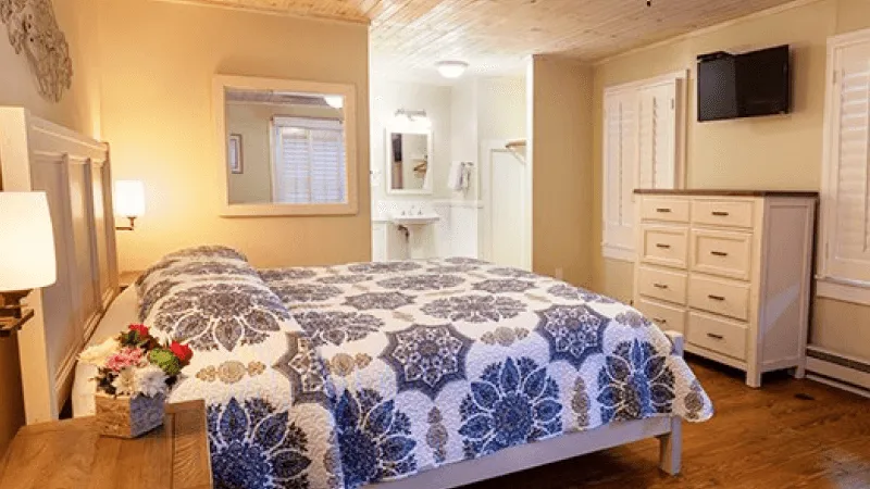 a bedroom with a bed and a mirror