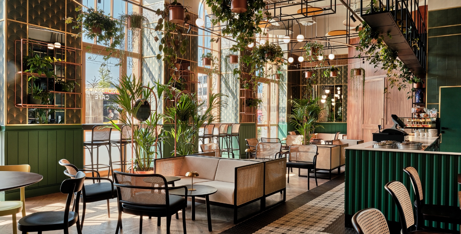 a room with tables and chairs and plants