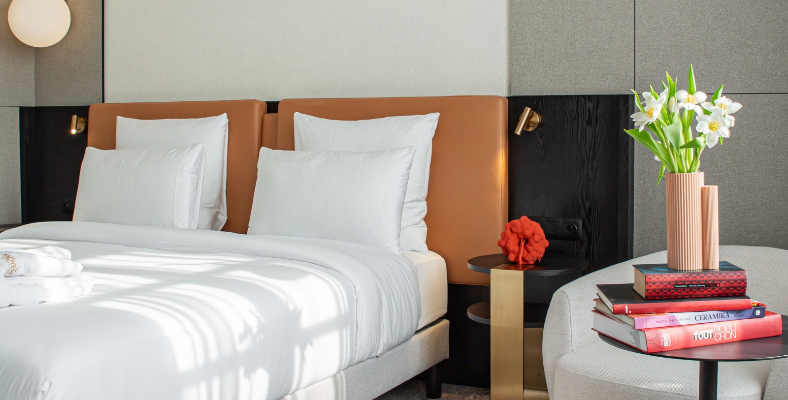 a bed with white pillows and a brown headboard