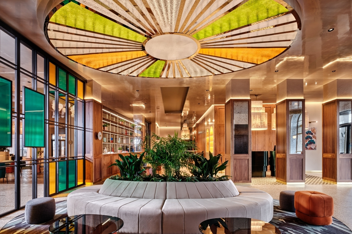 a room with a circular bench and a planter