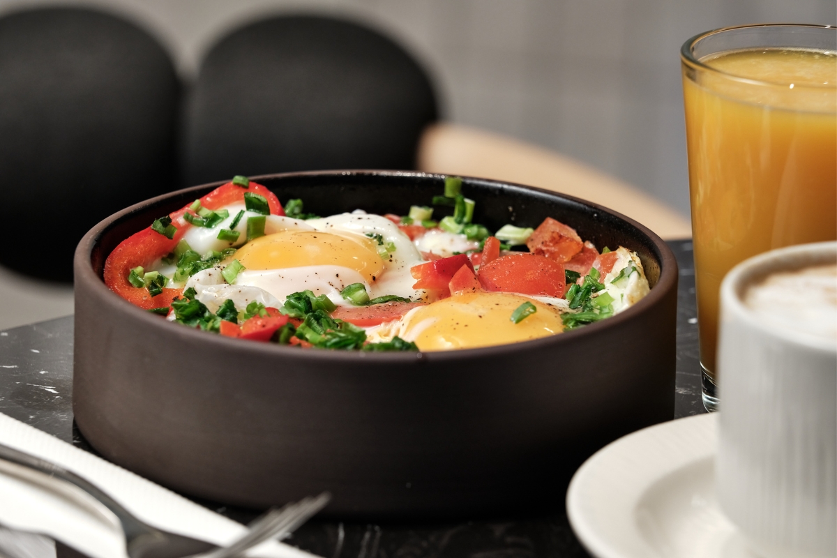 a bowl of food with eggs and vegetables