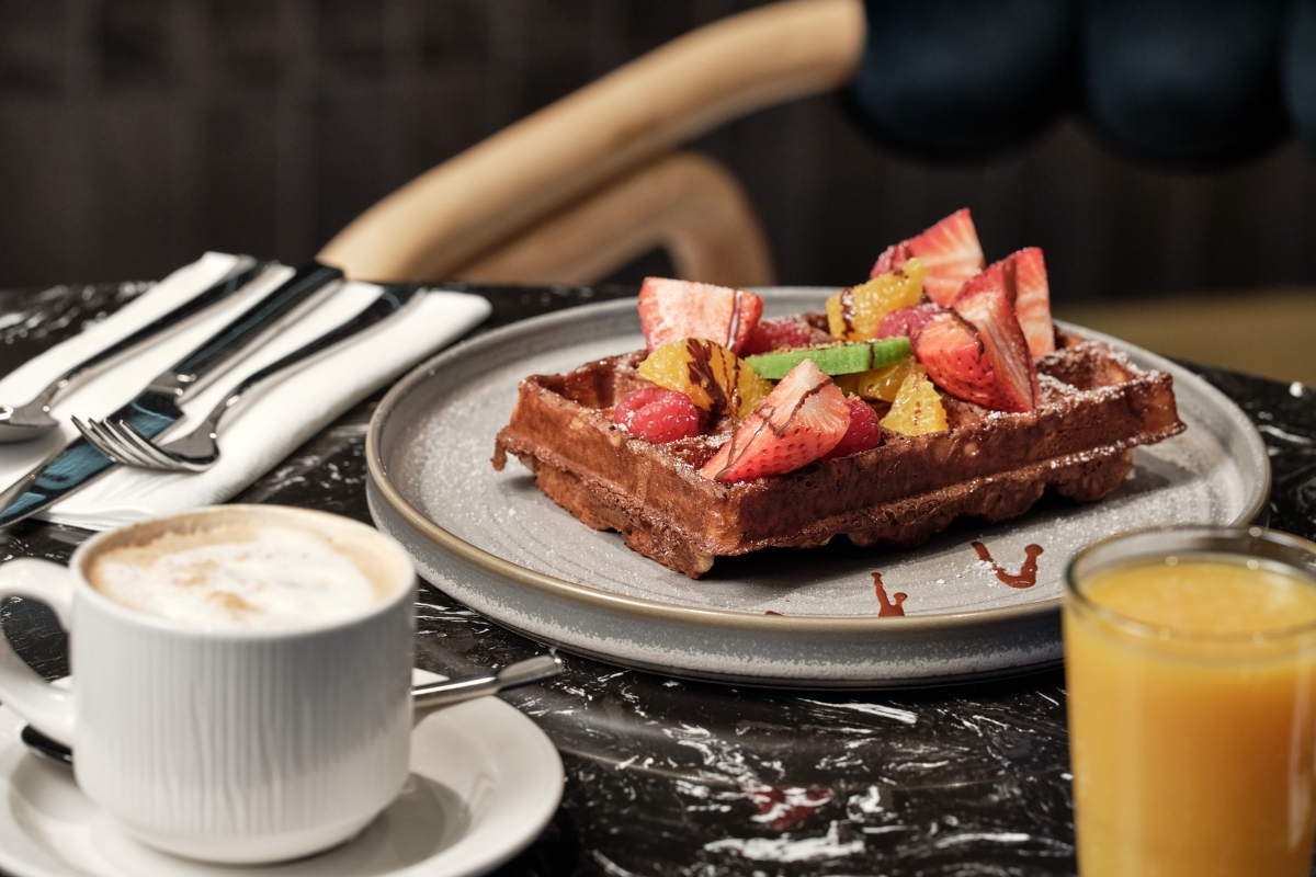a plate of waffles with fruit on top