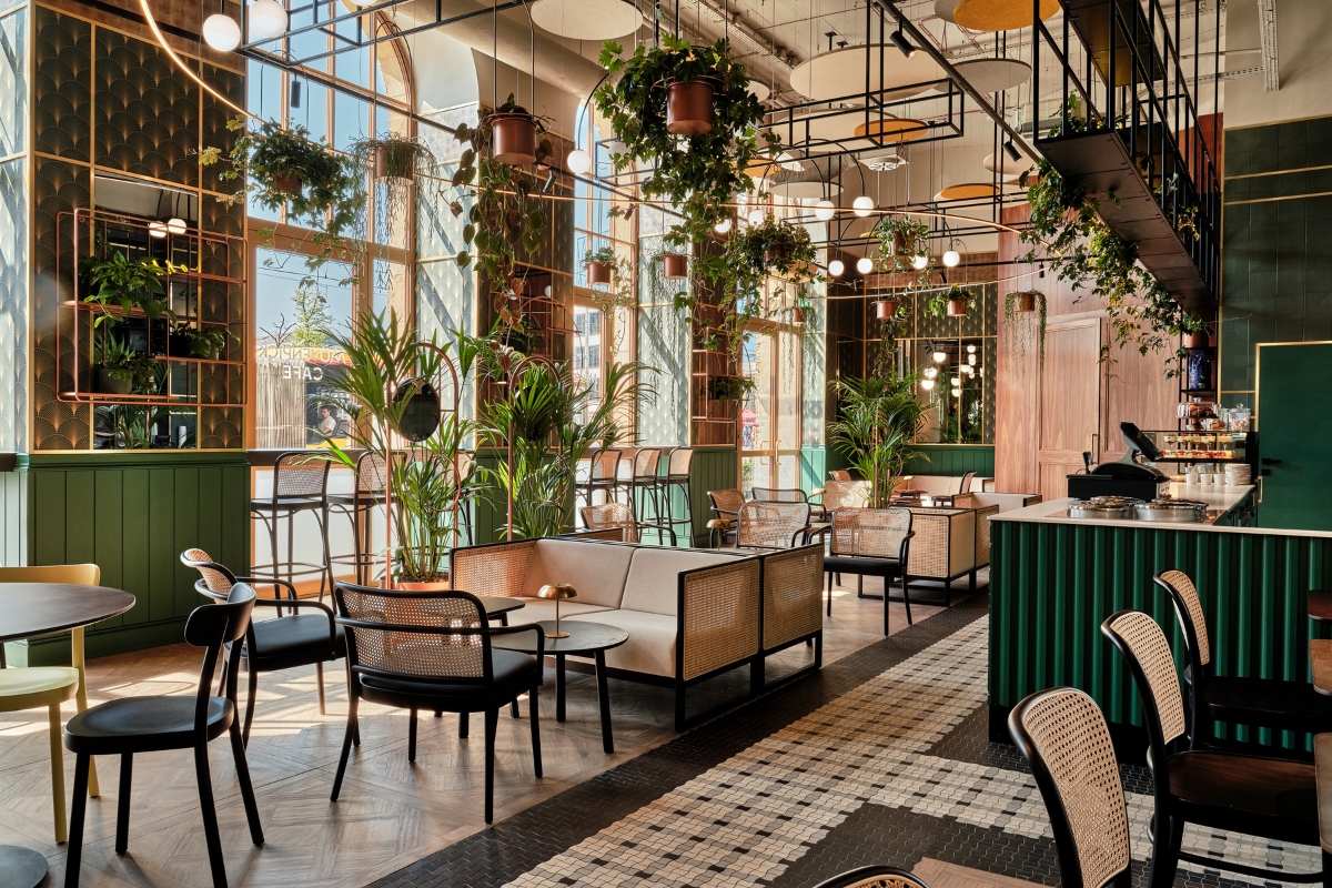 a room with tables and chairs and plants