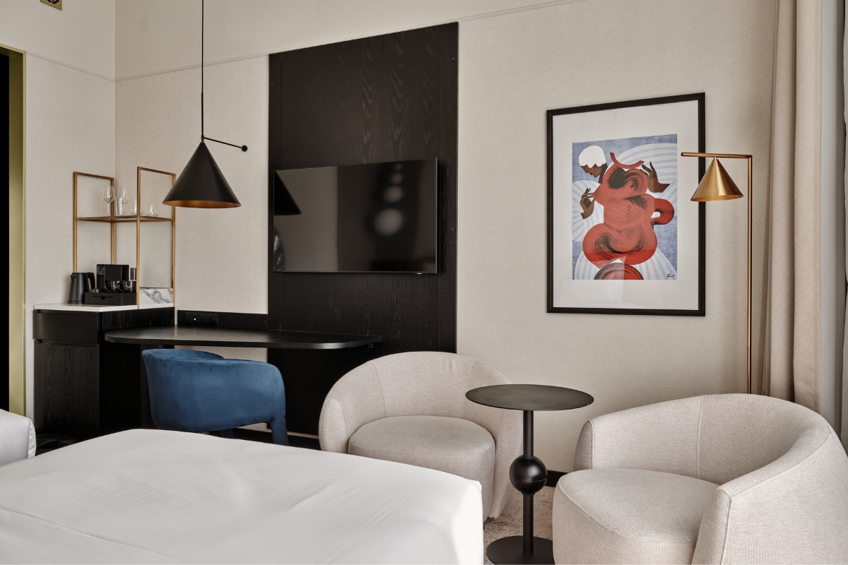 a room with a bed and a table and chairs