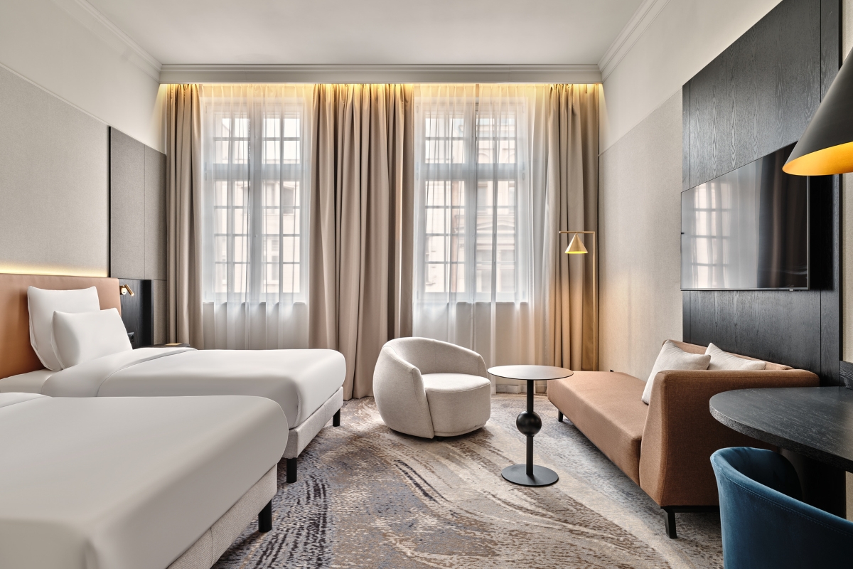 a room with two beds and a couch
