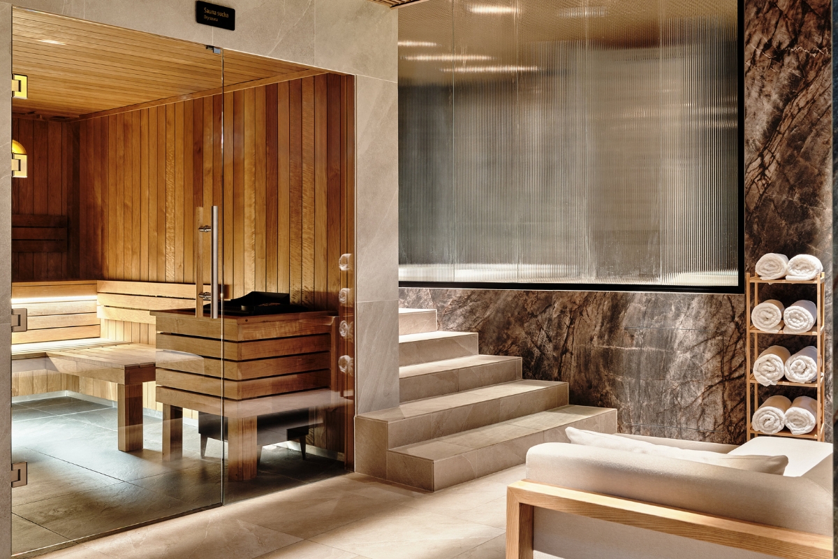a glass door leading to a sauna