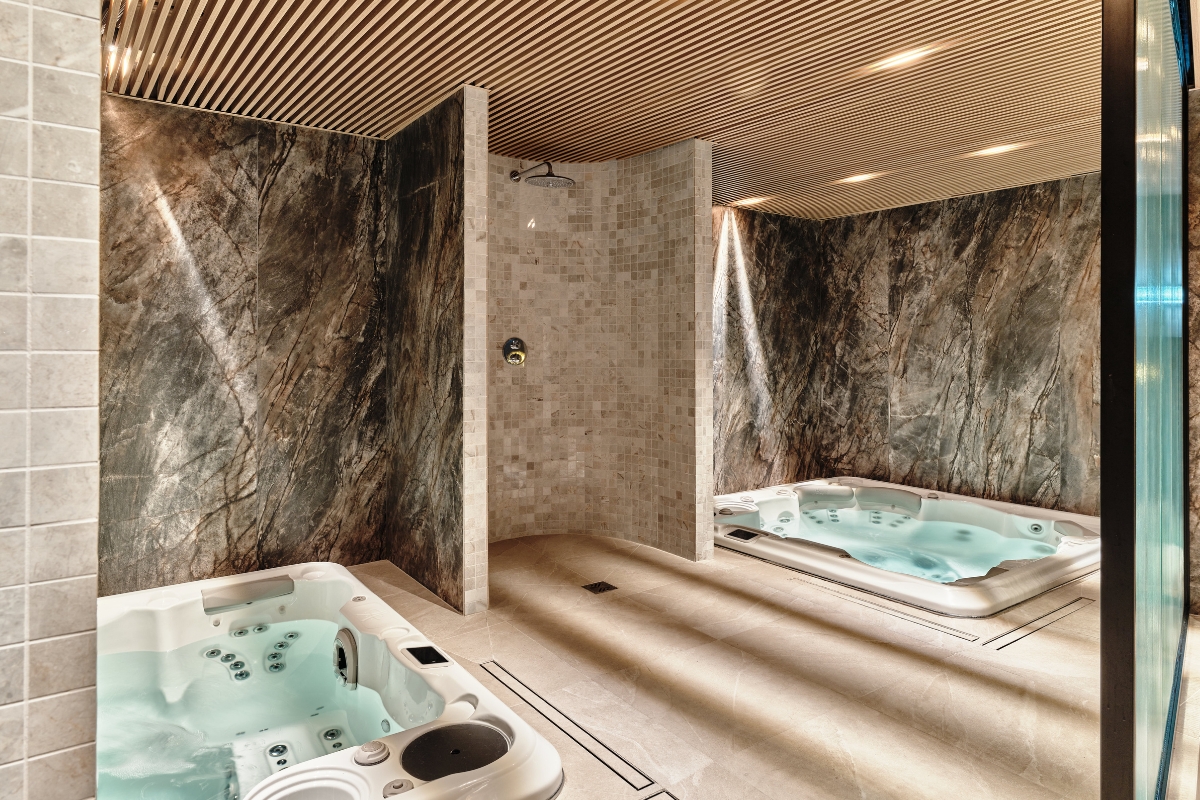 a room with hot tubs and marble walls