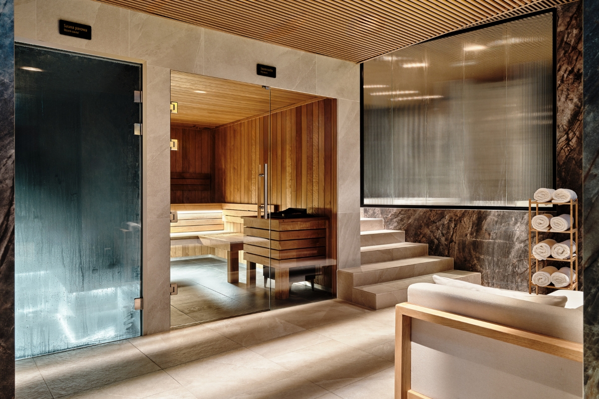 a room with a glass door and a wooden bench