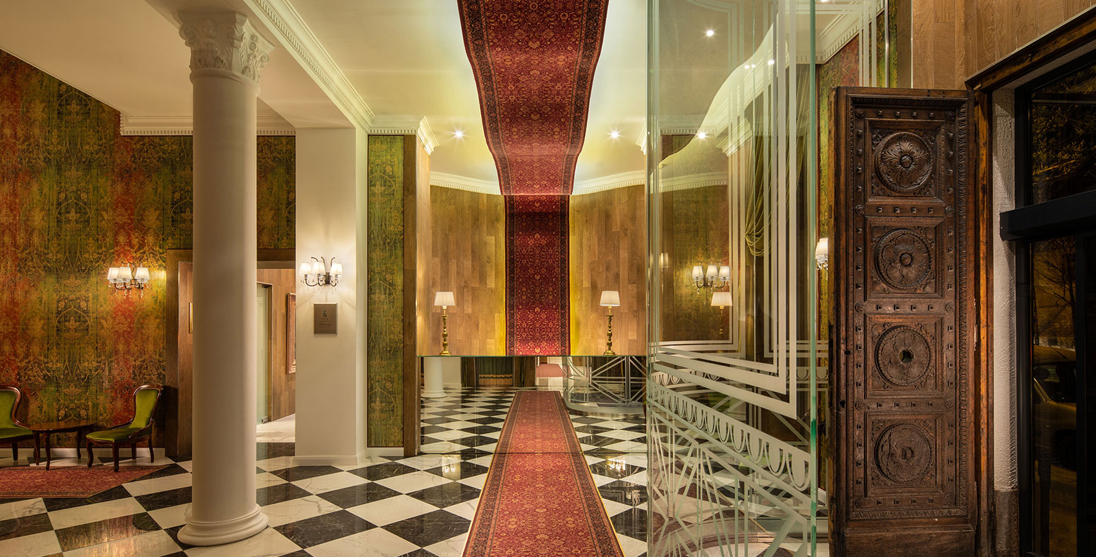a hallway with a red carpet and a black and white checkered floor