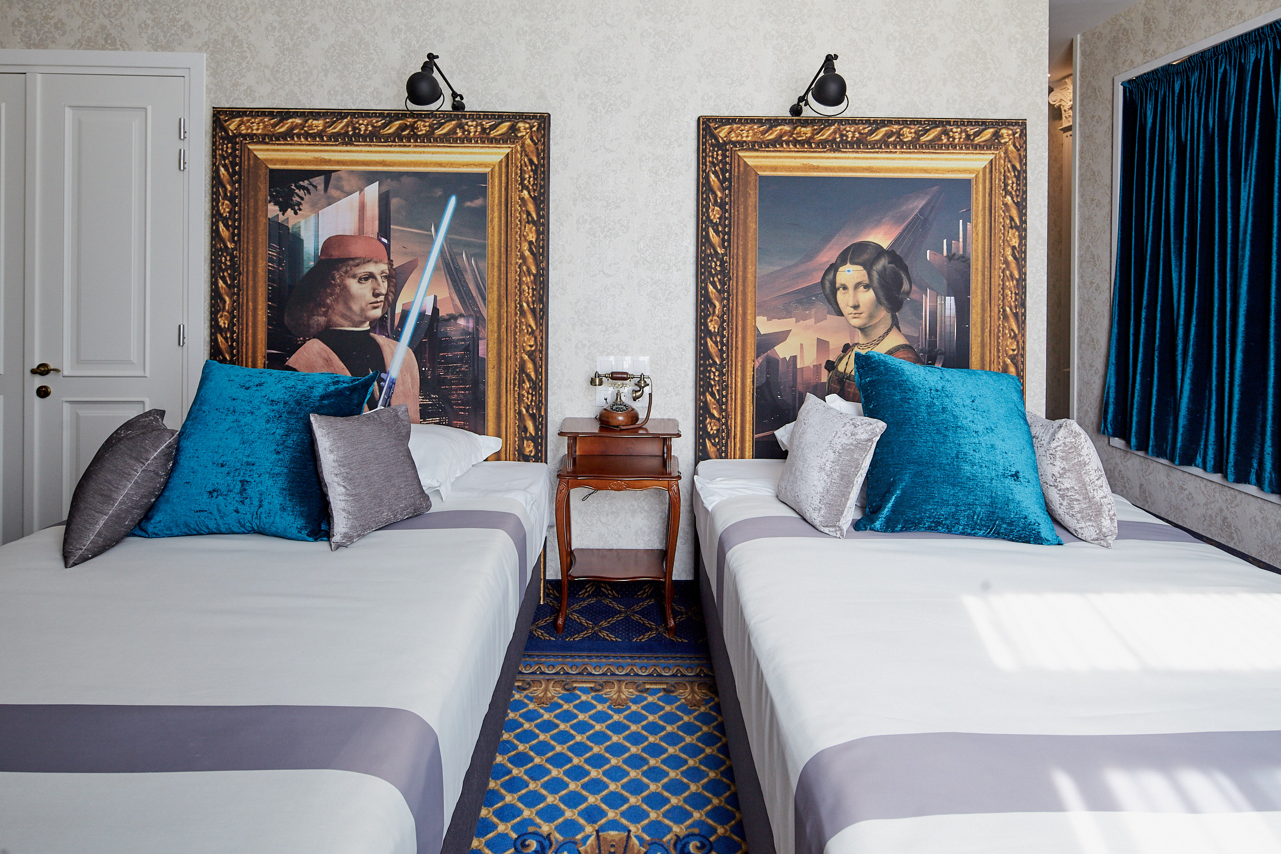 two beds with two large framed pictures