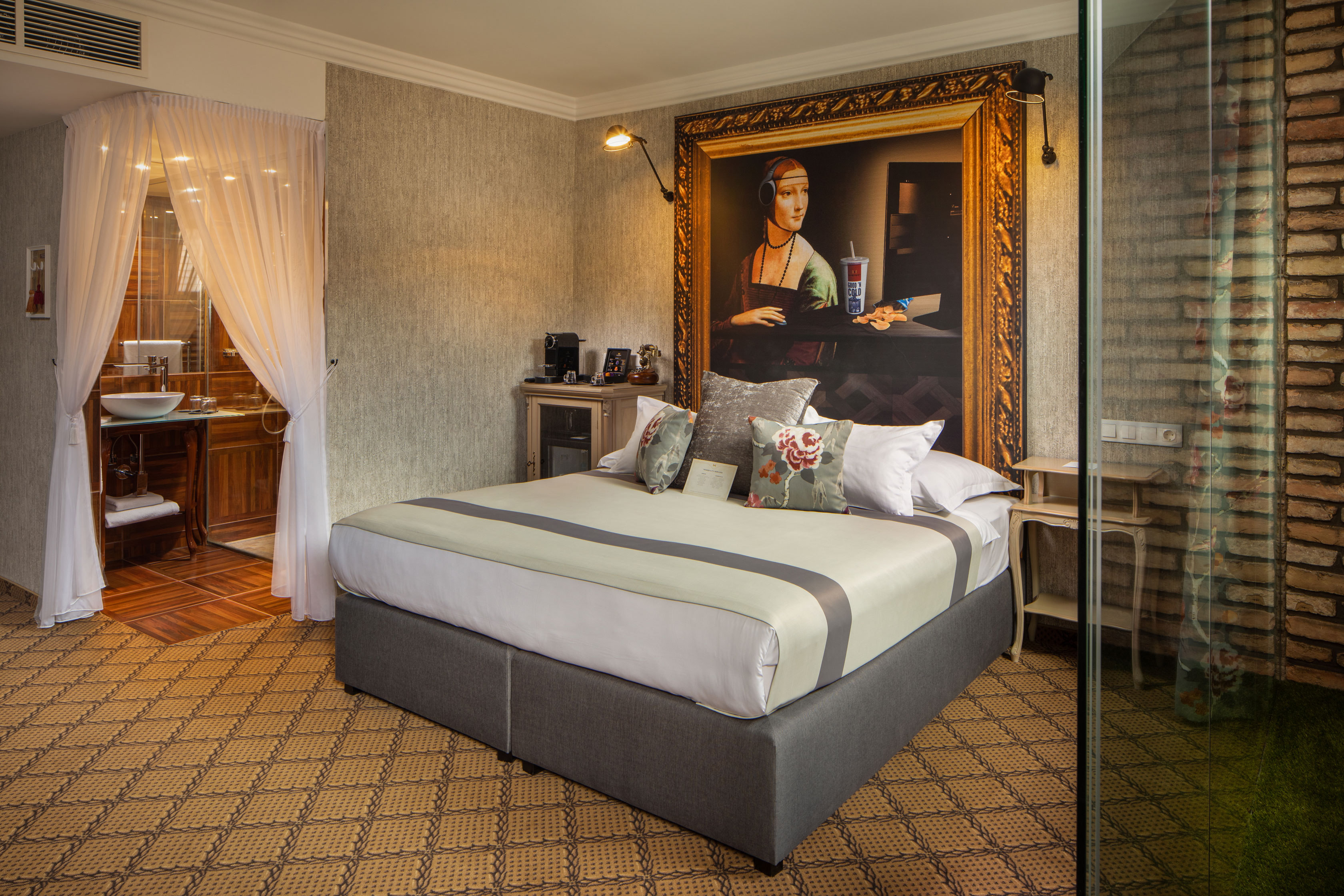a bed with a painting on the wall