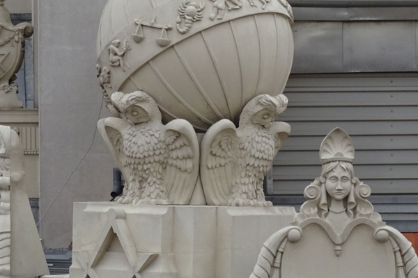 a statue of two owls and a globe