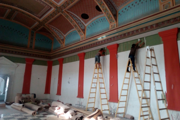 people on ladders in a room