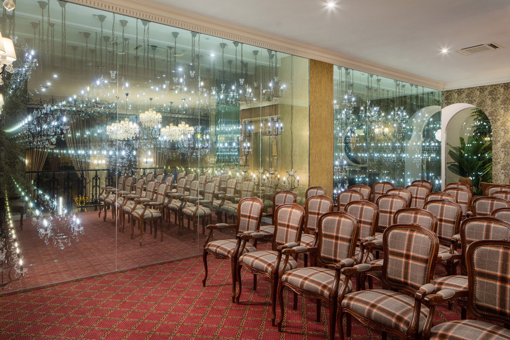 a room with many chairs and chandeliers