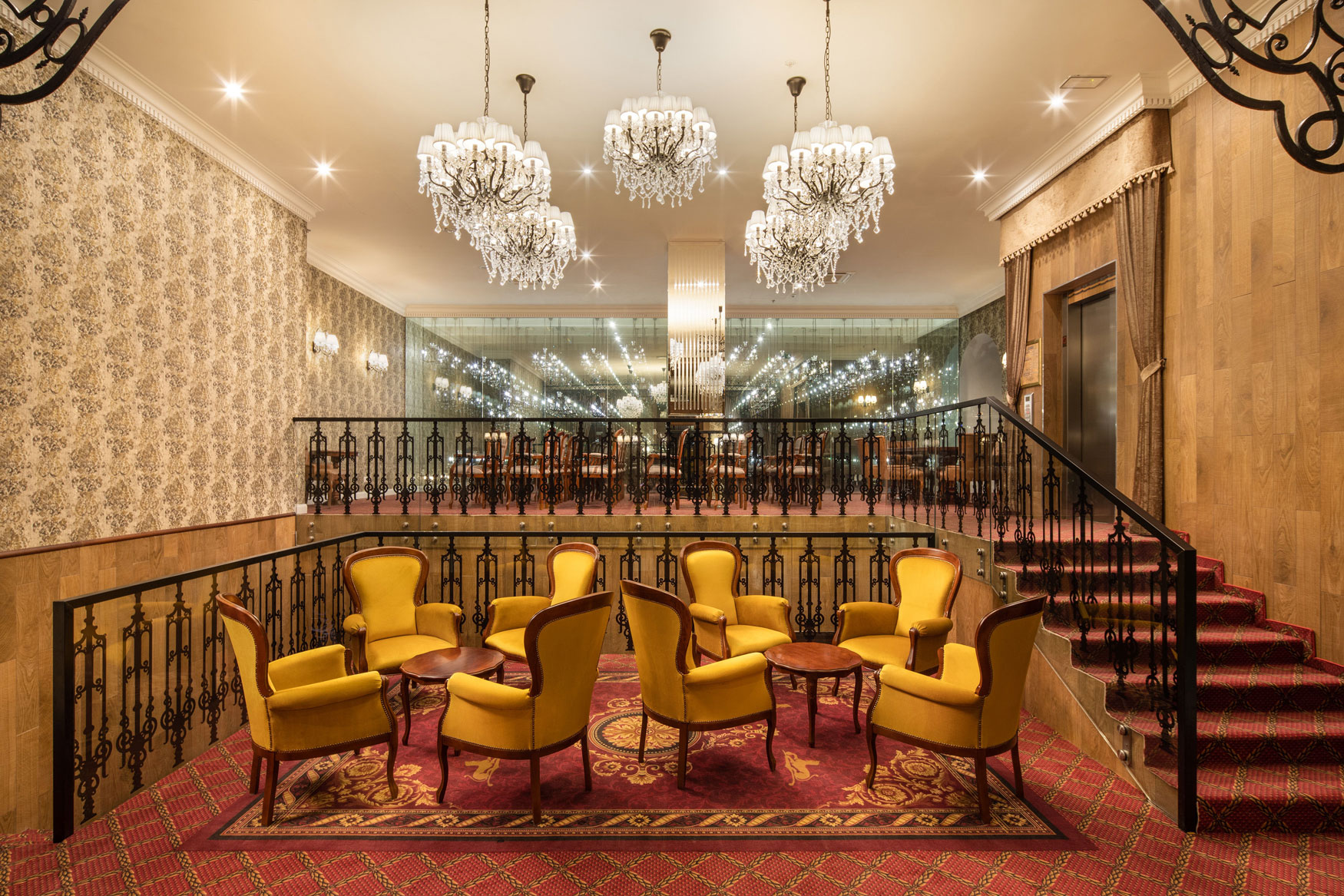 a room with chandeliers and chairs