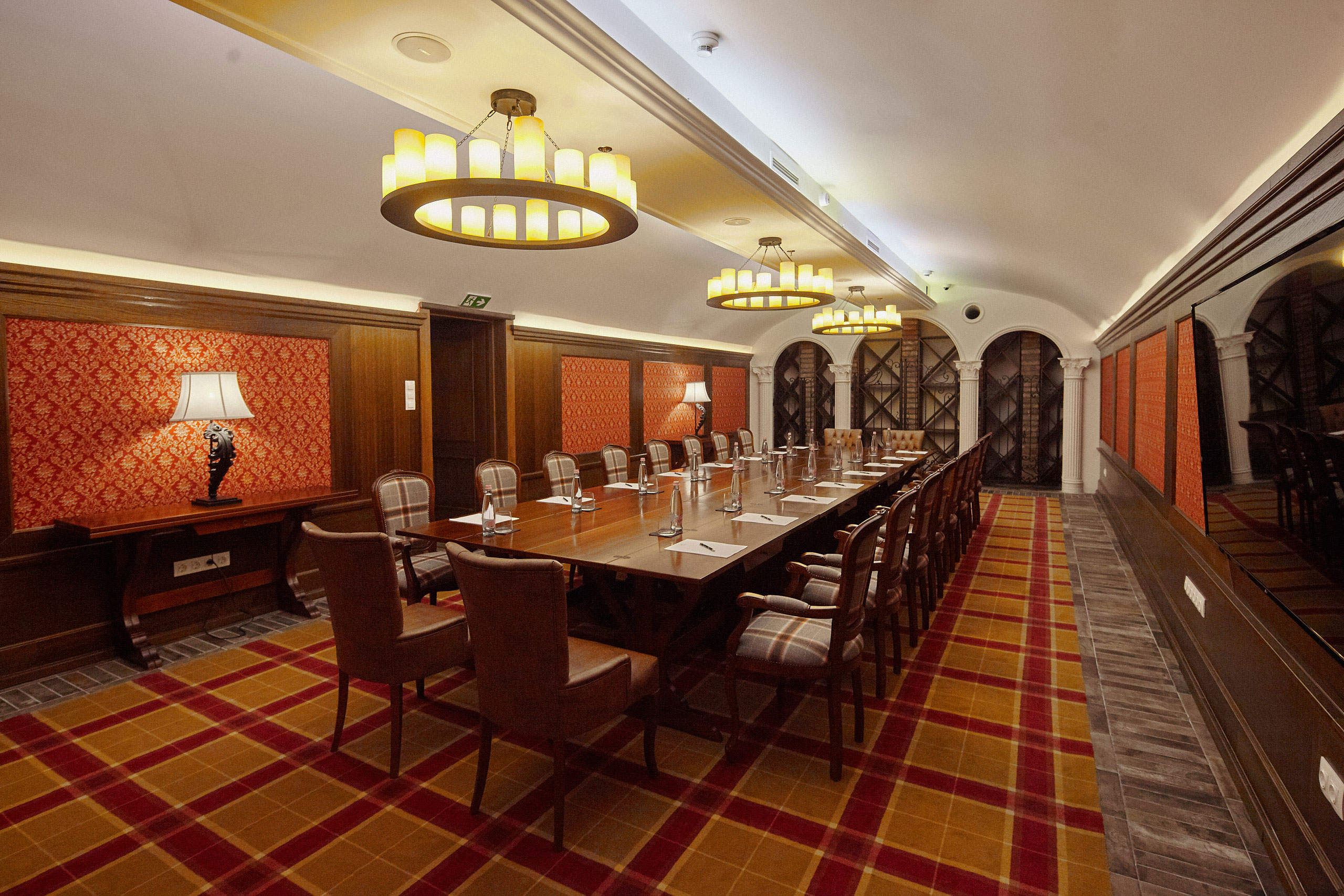 a long table with chairs and a chandelier